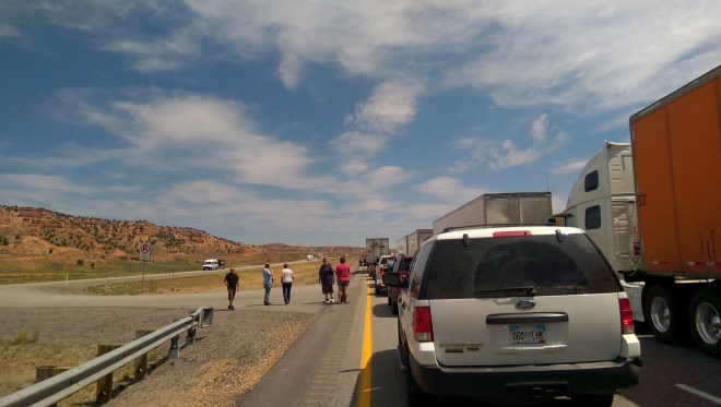 People gather out of their cars, on  the road, as we wait for an accident about a mile ahead to be cleared.